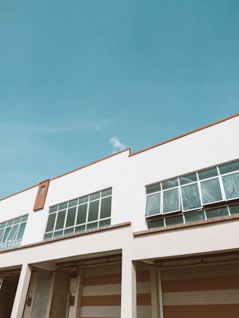 A modern industrial building with large glass windows.