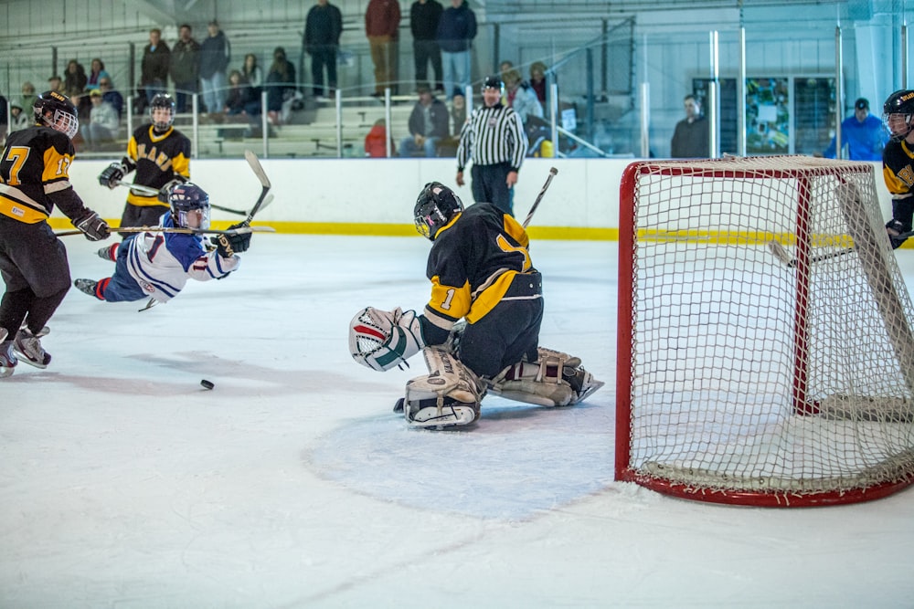 man in yellow and black jersey shirt playing ice hockey