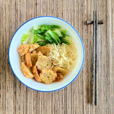 A steaming bowl of premium ramen with vibrant vegetables and tofu.