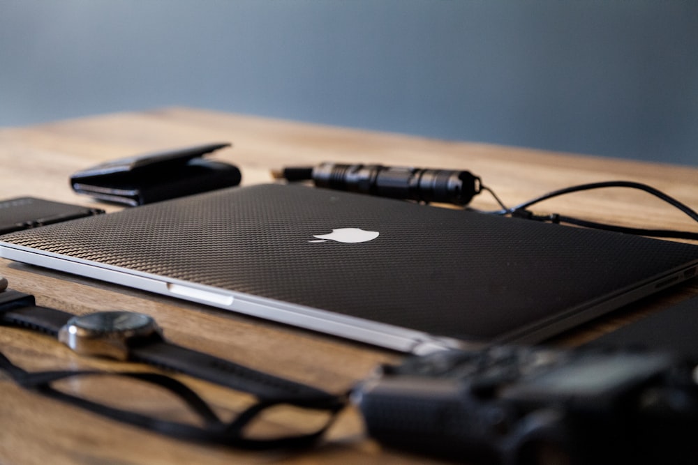 macbook pro on brown wooden table