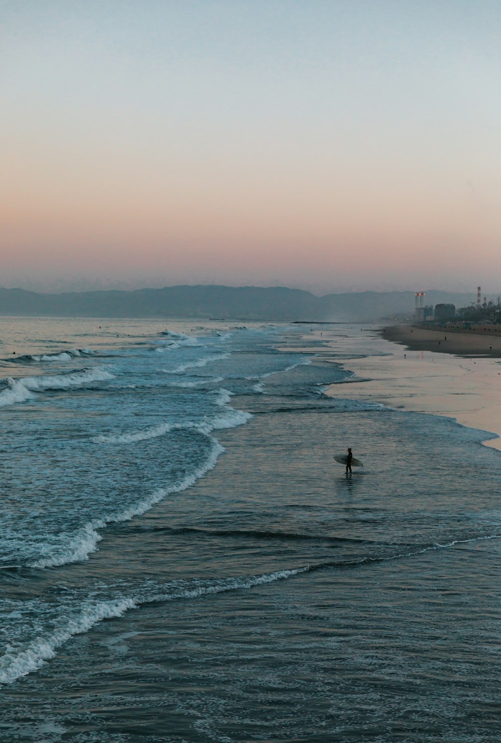 person standing on beach shore during daytime