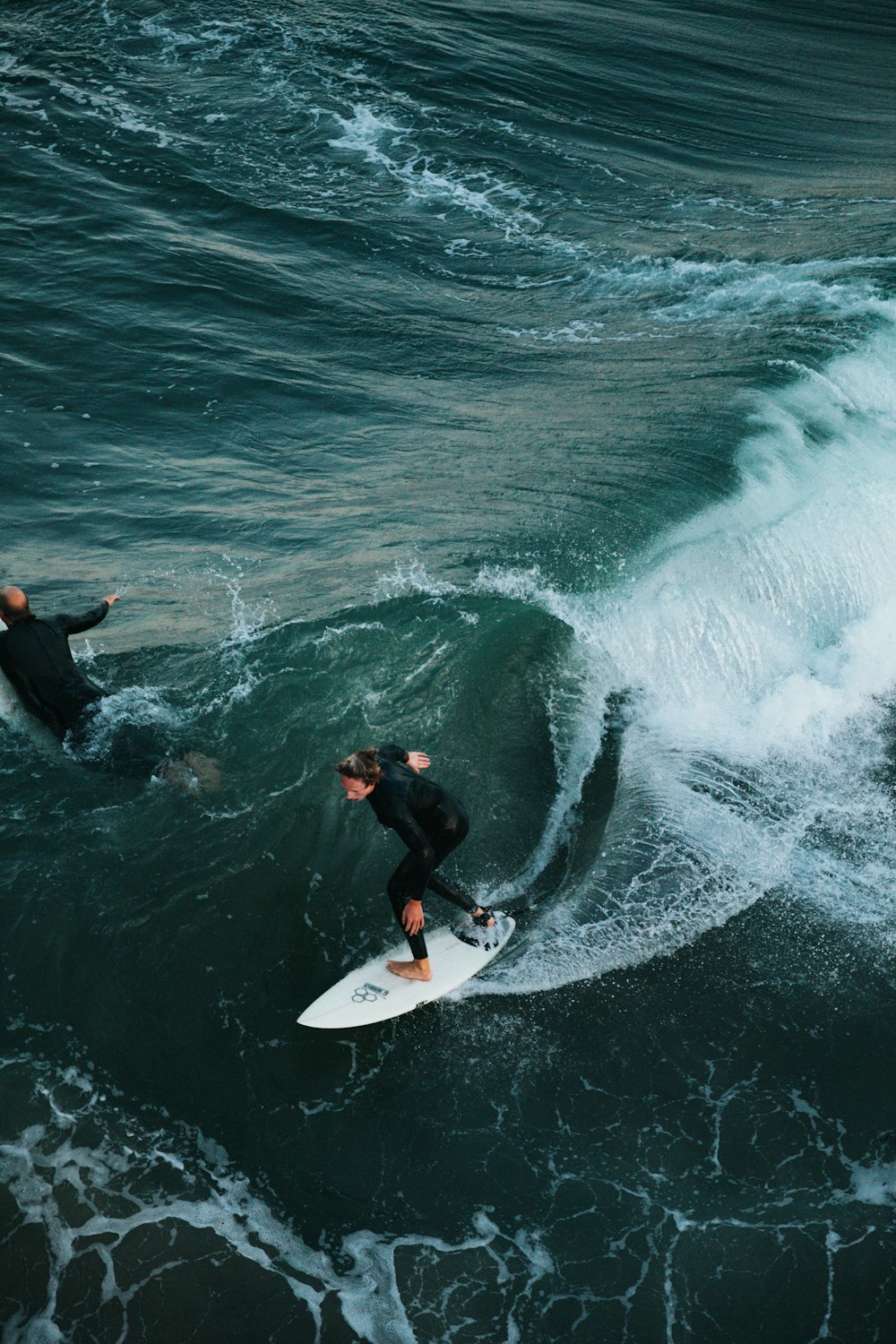 man surfing on sea waves during daytime