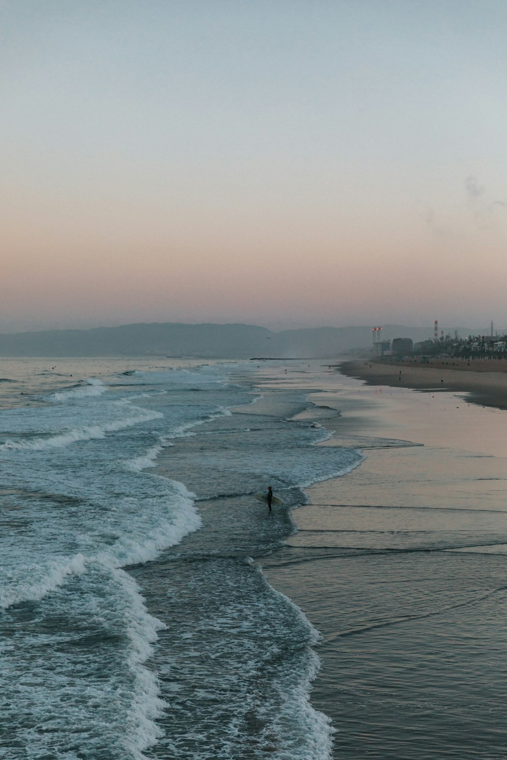 sea waves crashing on shore during daytime