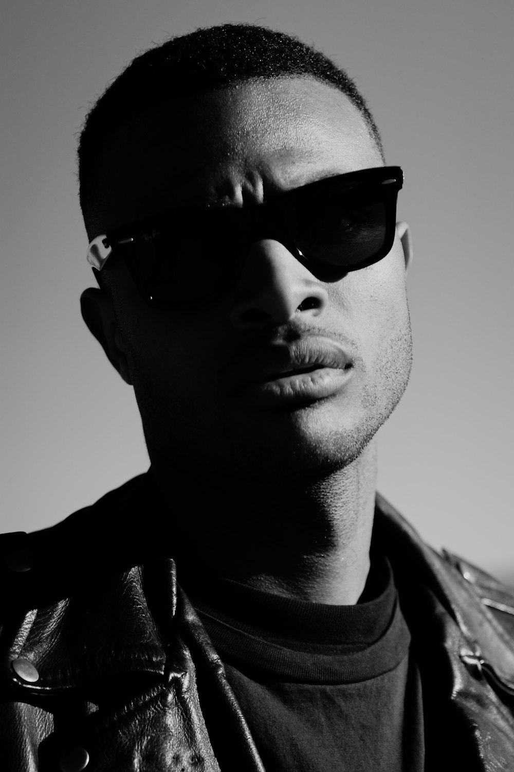 man wearing black sunglasses and black jacket