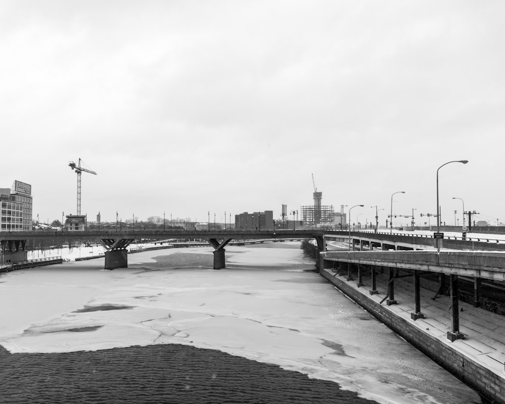 grayscale photo of bridge over river