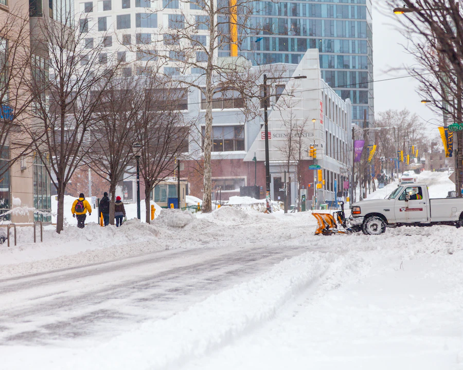 Snow removal truck clearing a plowed commercial street