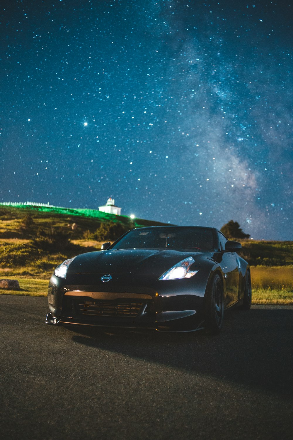 black car on road during night time