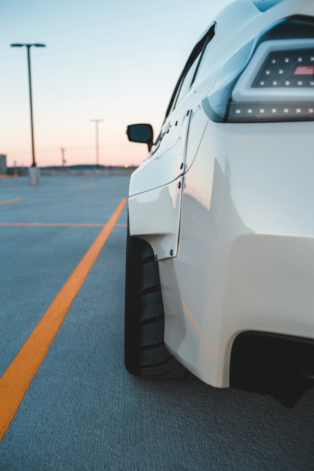 white car on gray asphalt road during daytime