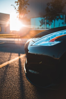 A shiny, well-maintained car parked under sunlight.