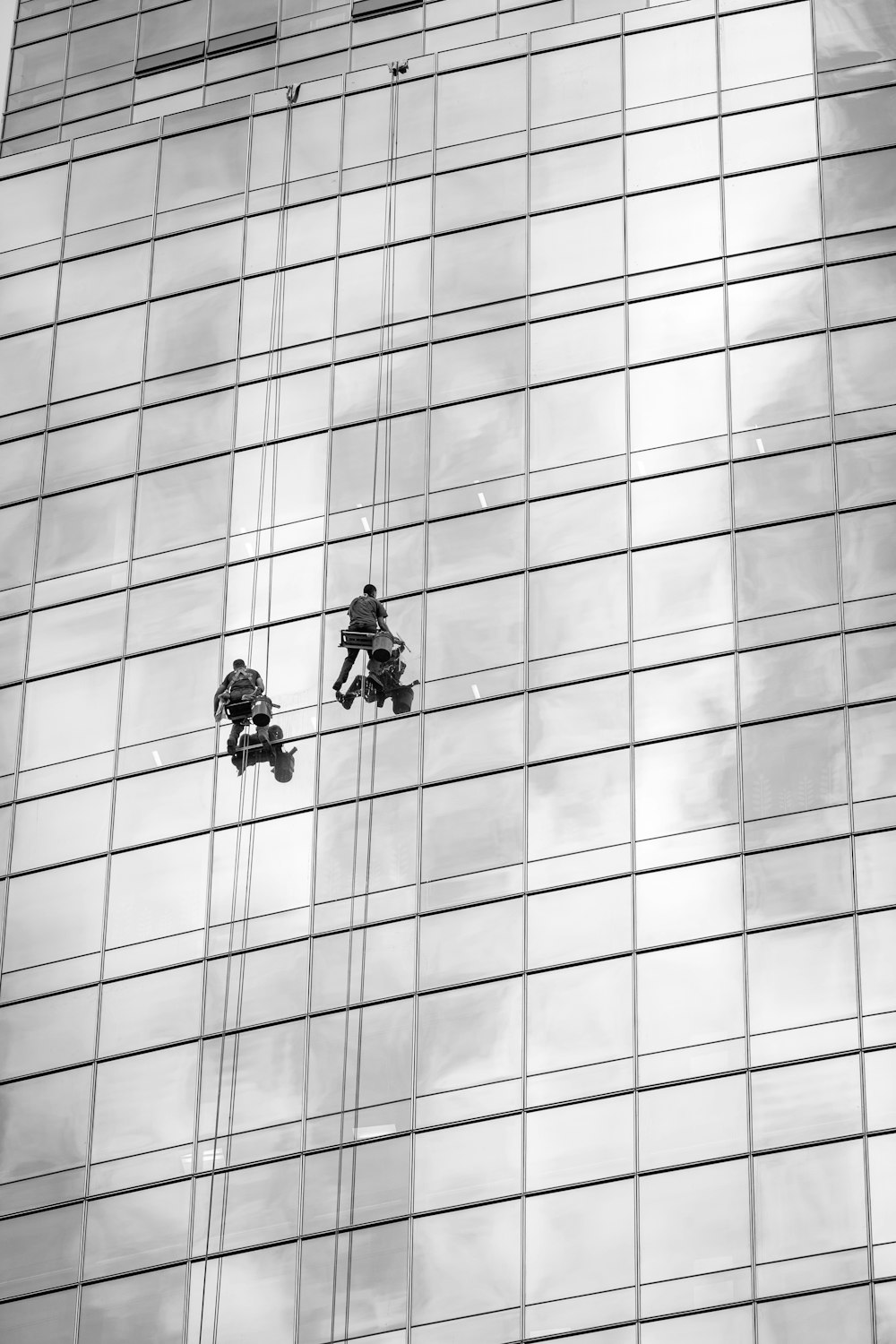 2 person in black jacket riding bicycle in grayscale photography