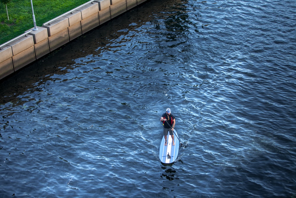 woman in white and red dress on water during daytime