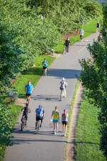 people riding bicycle on road during daytime