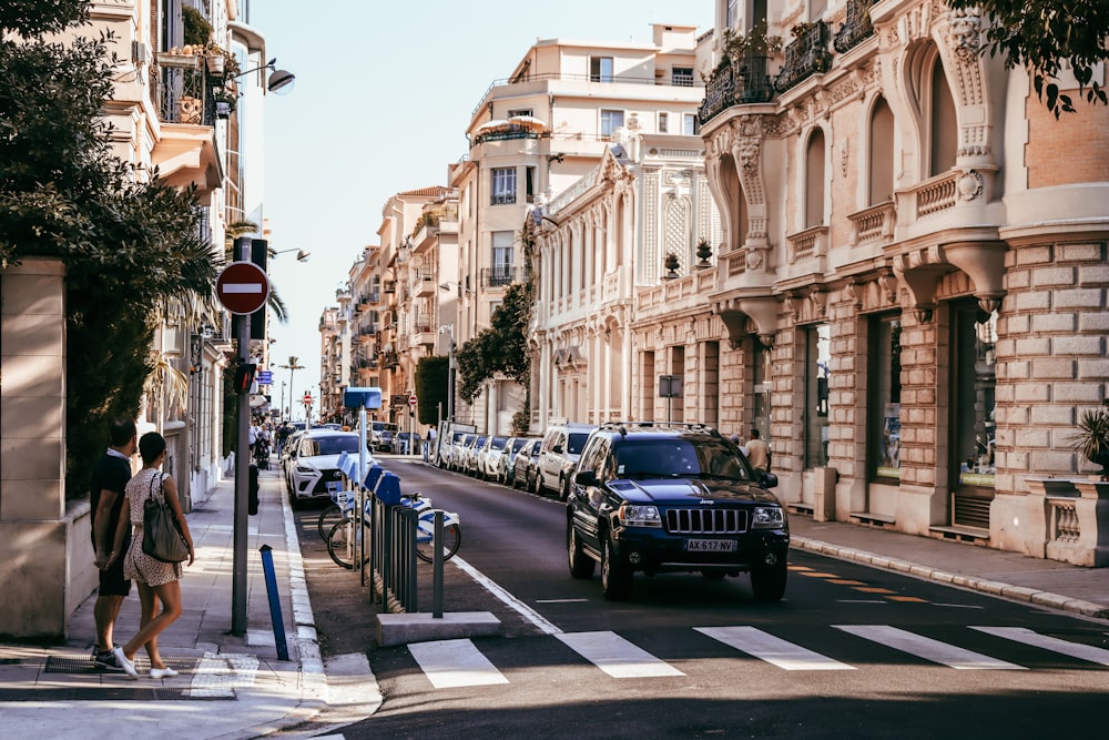 cars parked on sidewalk near buildings during daytime