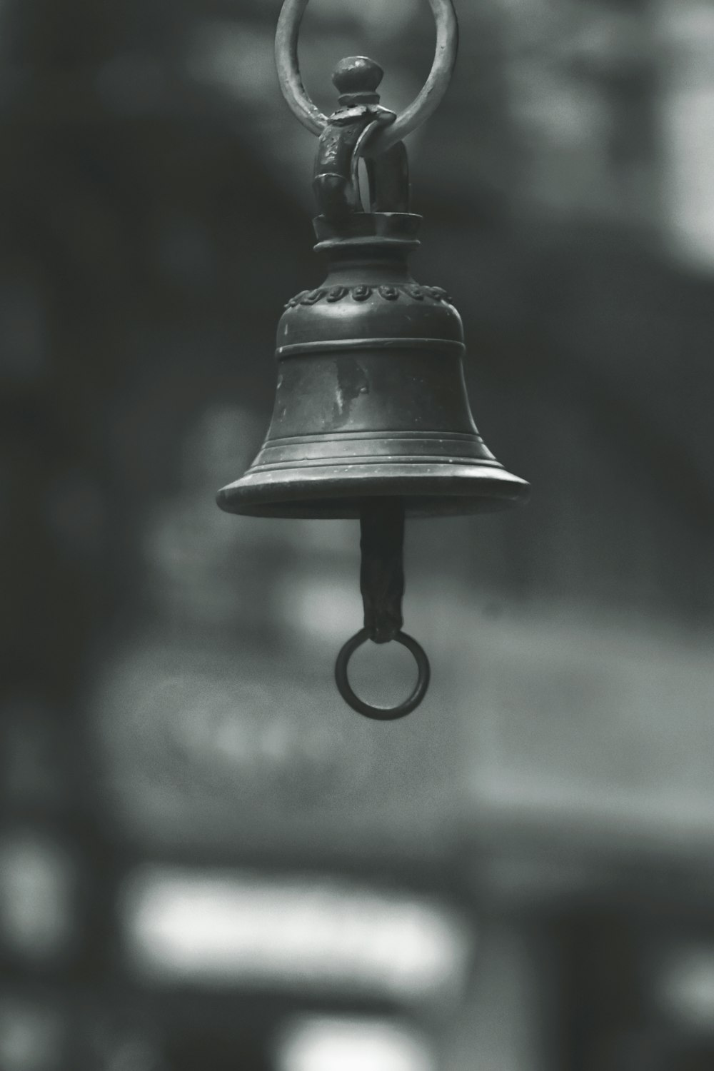 black steel bell on brown wooden table