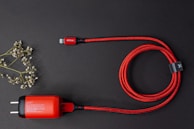 A stylish charging cable neatly coiled on a wooden surface.