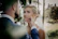 Bride and groom laughing naturally in a softly lit outdoor setting.
