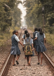 people walking on train rail during daytime