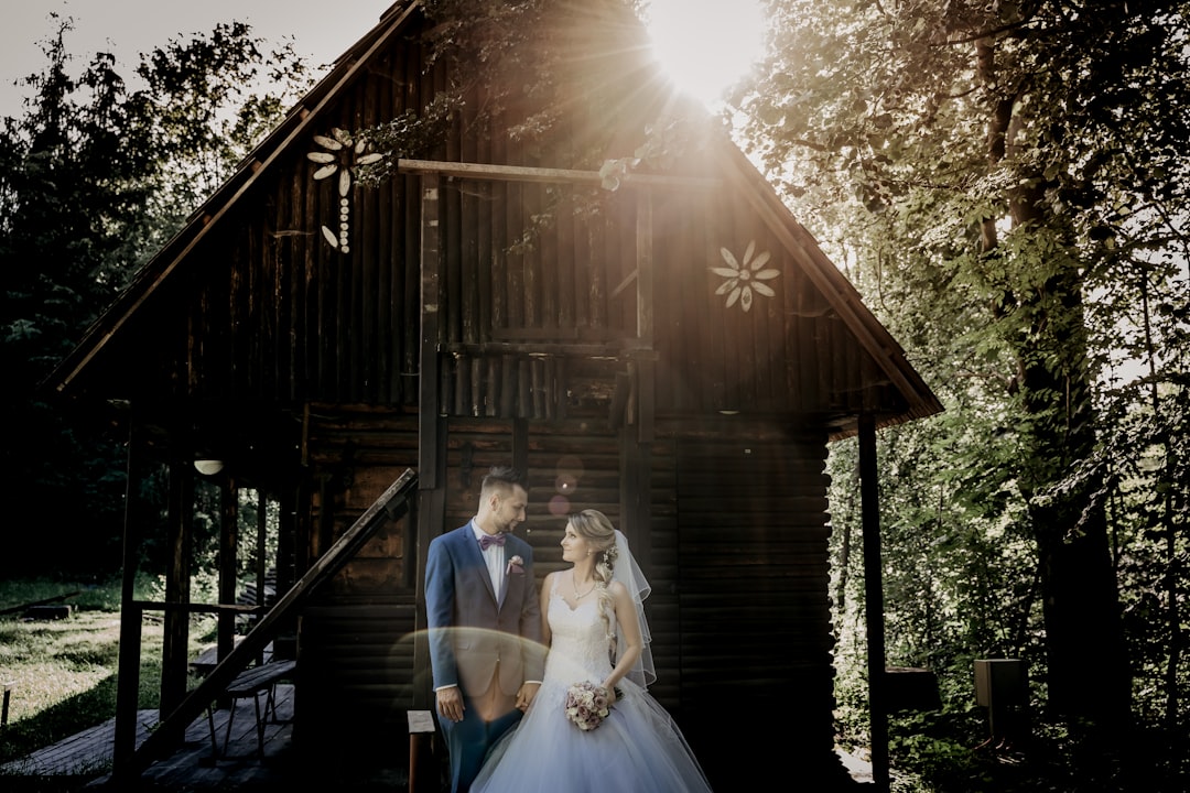 bride and groom standing on wooden house