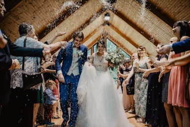 bride and groom standing beside brown wooden wall