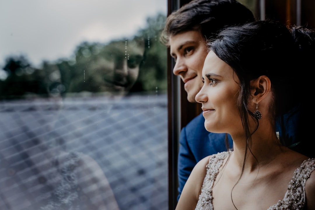 woman in white floral lace tank top looking at the window