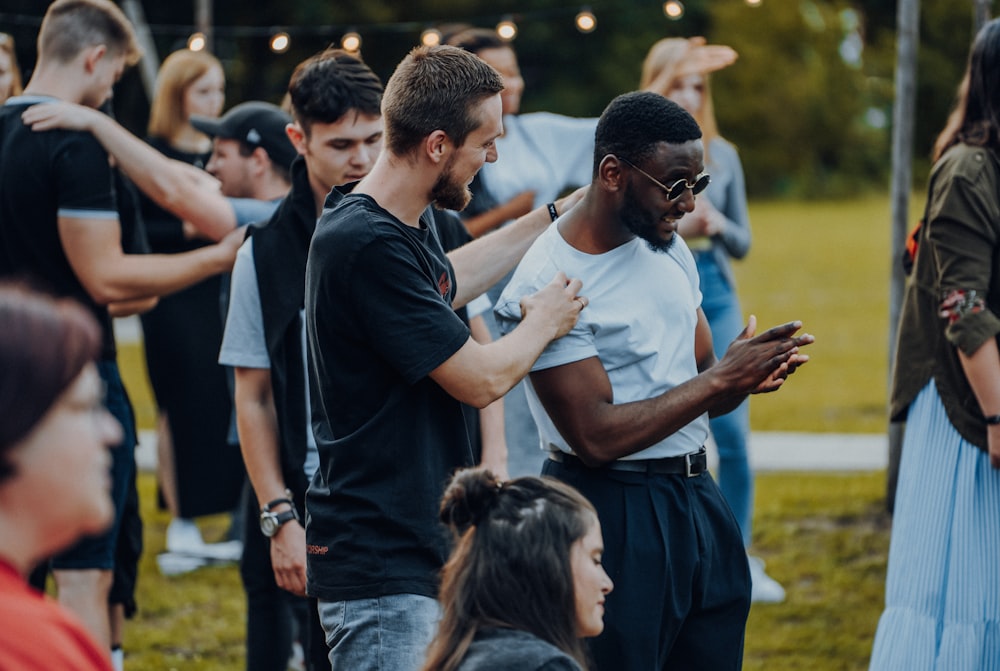 man in black t-shirt standing beside woman in white t-shirt