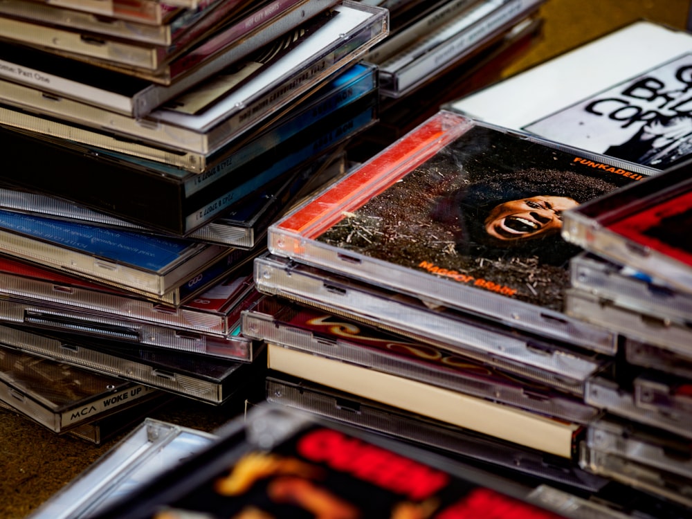 stack of books on brown wooden table