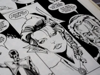 A close-up of a hand-drawn comic panel showing detailed character emotions.