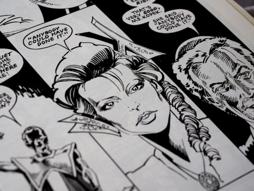 A close-up view of a black and white comic book page featuring detailed illustrations of characters with speech bubbles. The main character has a braided hairstyle, and the speech text includes a dialogue questioning who could have done something.
