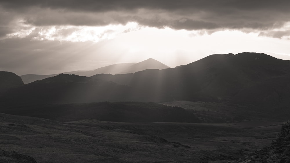 silhouette of mountains under cloudy sky during daytime