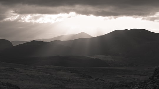 silhouette of mountains under cloudy sky during daytime in Snowdon United Kingdom