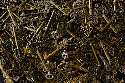 A collection of metal and leather keychains arranged neatly on a rustic table.