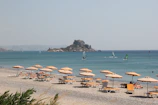brown wooden beach lounge chairs on beach during daytime