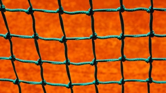 Close-up of a sturdy industrial safety net woven with thick, durable fibers.