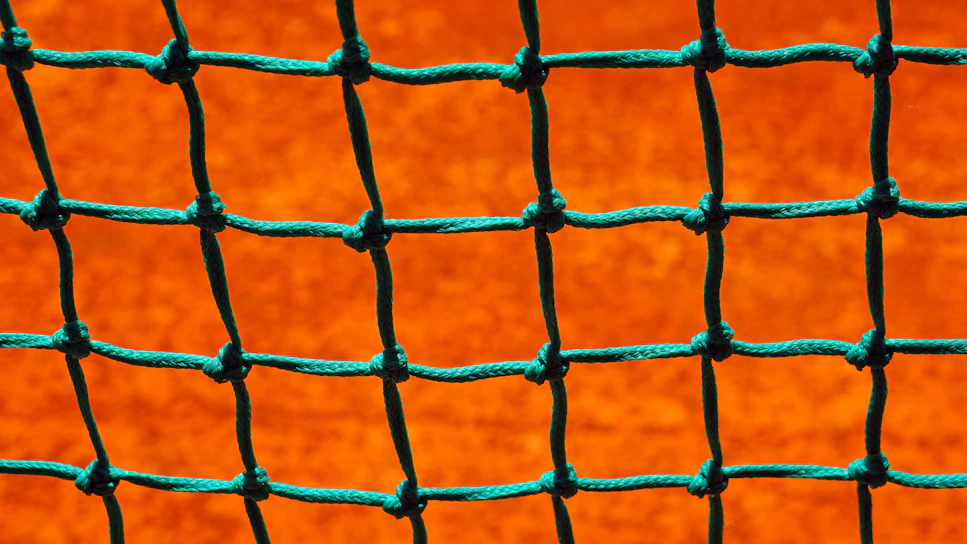 Close-up of a durable safety net stretched tightly across a construction site.