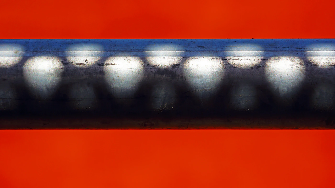 Close-up of a solid round metal bar surface