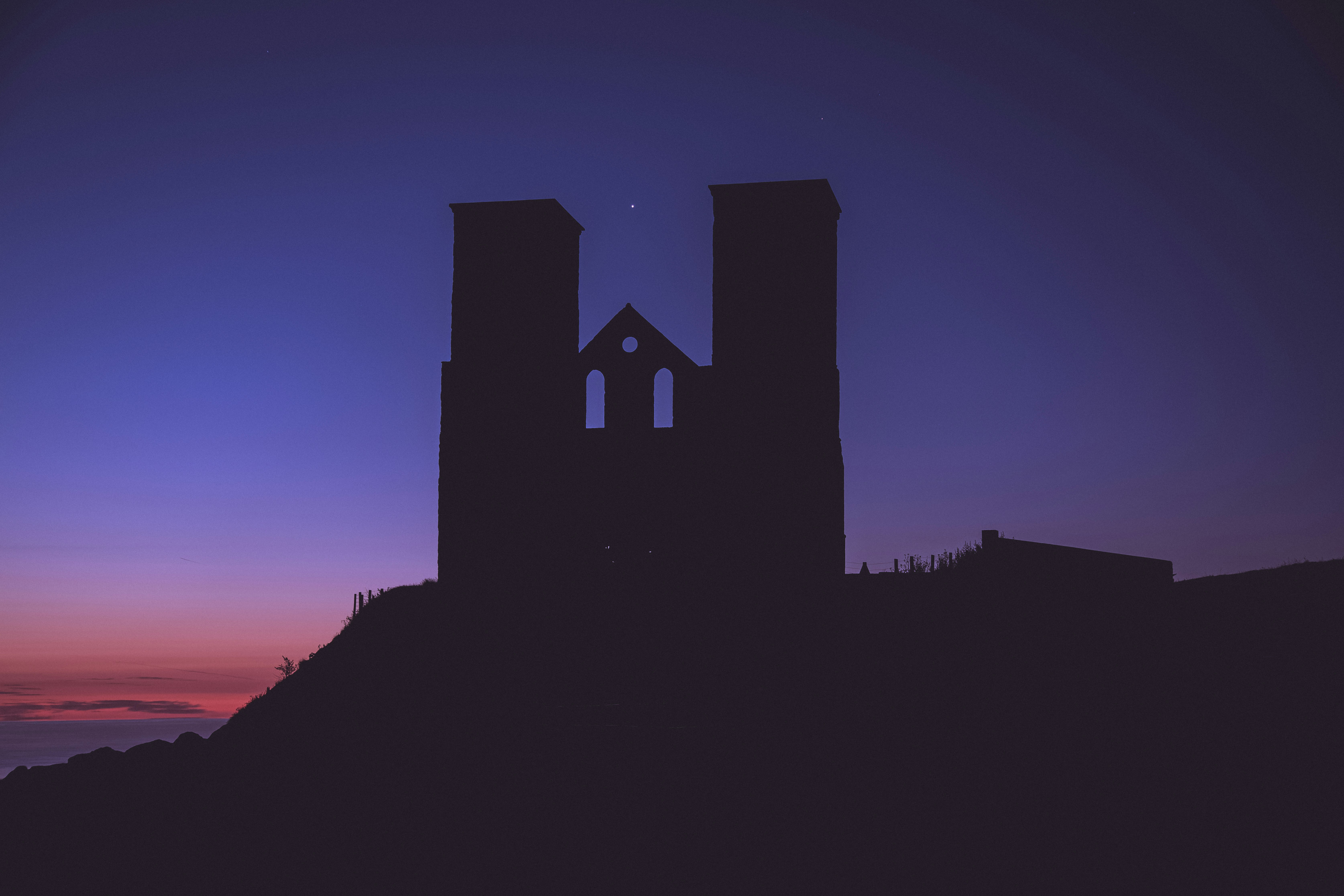 silhouette of building during night time