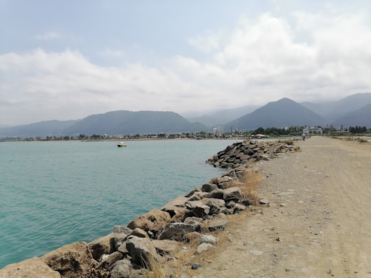 brown rocks near body of water during daytime in Ramsar Iran