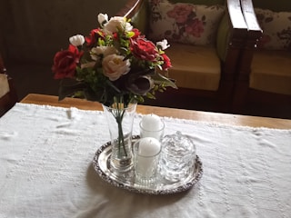 Decorative trays arranged with candles and flowers.