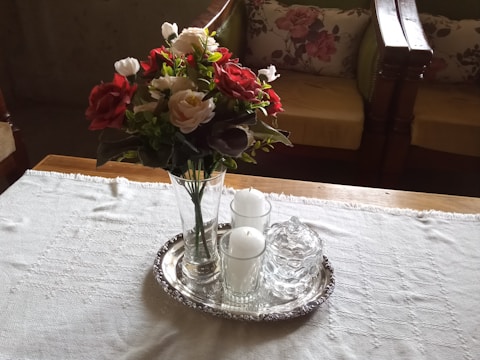 Decorative trays arranged with candles and flowers.