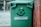A satisfied customer giving a thumbs up next to a dumpster.