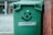 A smiling customer standing next to a freshly cleaned bin.