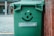 A happy customer giving a thumbs up next to a dumpster.