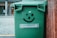 A smiling customer standing next to a freshly cleaned bin.
