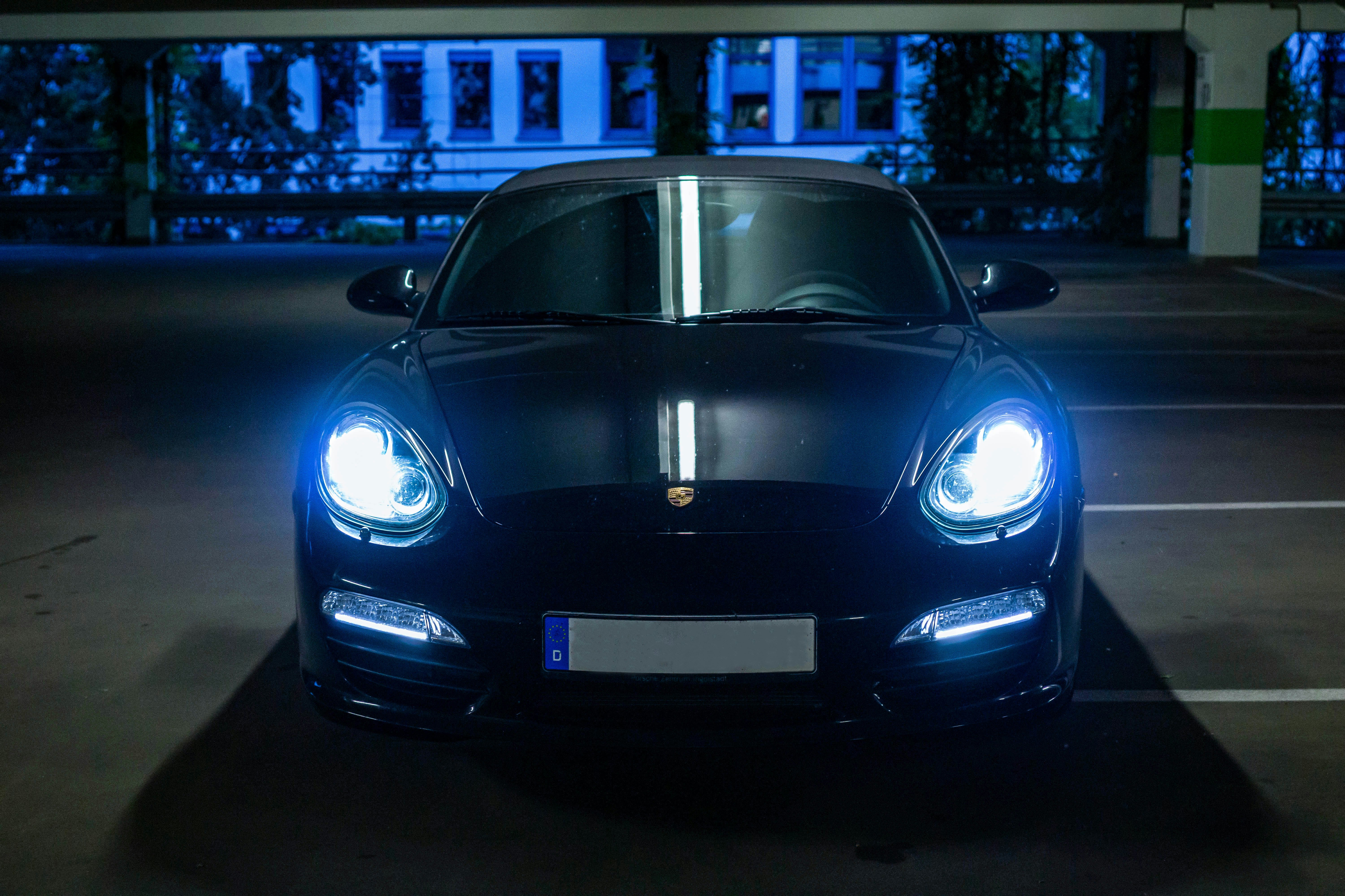 black porsche 911 parked on parking lot during night time