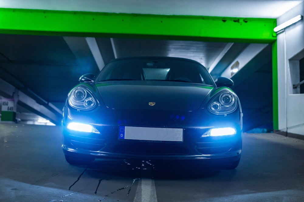 blue porsche 911 parked in garage