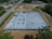 Aerial view of a construction site with a drone in the foreground.