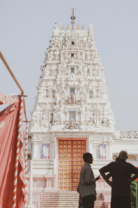 people walking near white concrete building during daytime in Pushkar Temple India