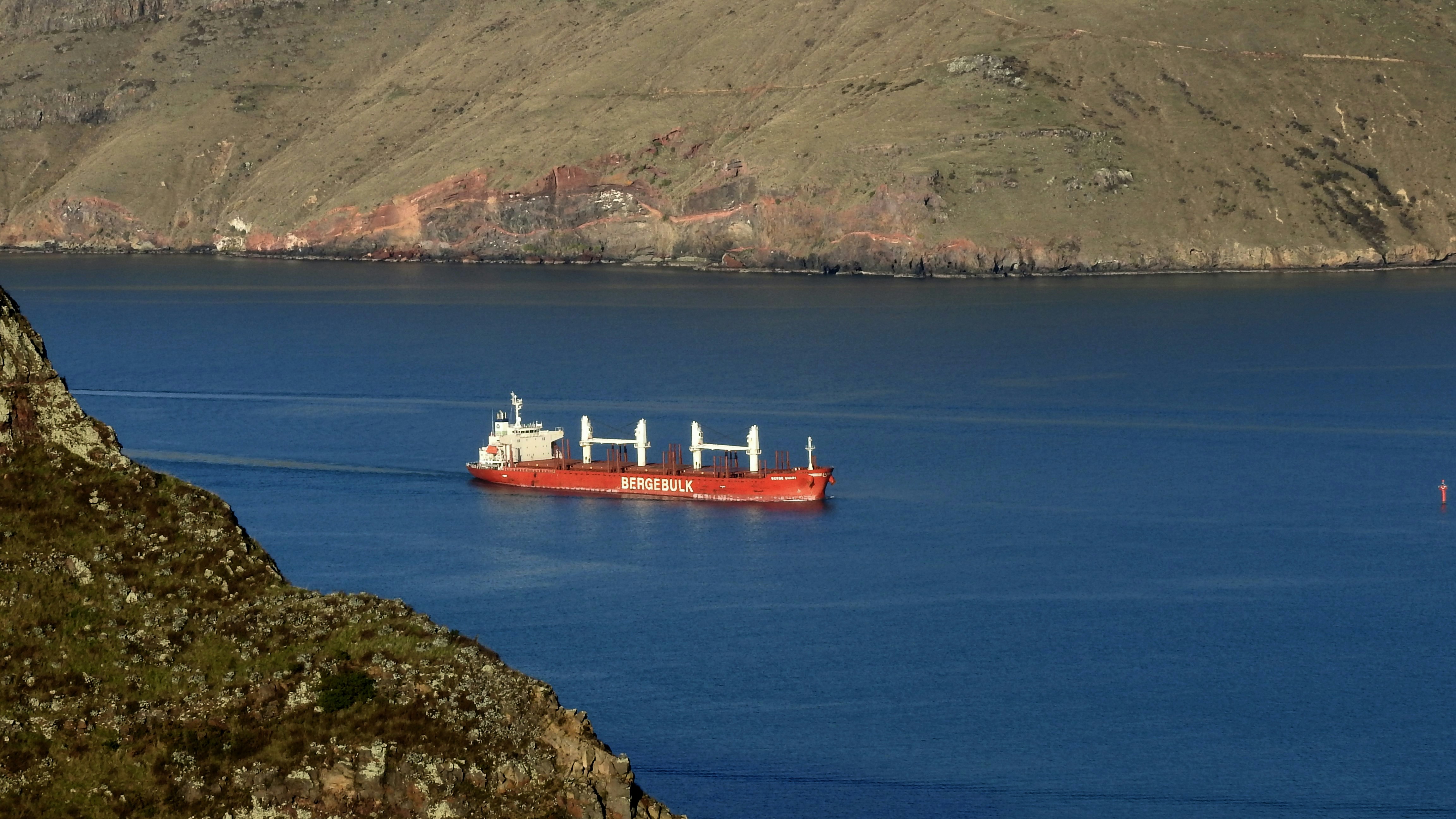 red ship on blue sea during daytime