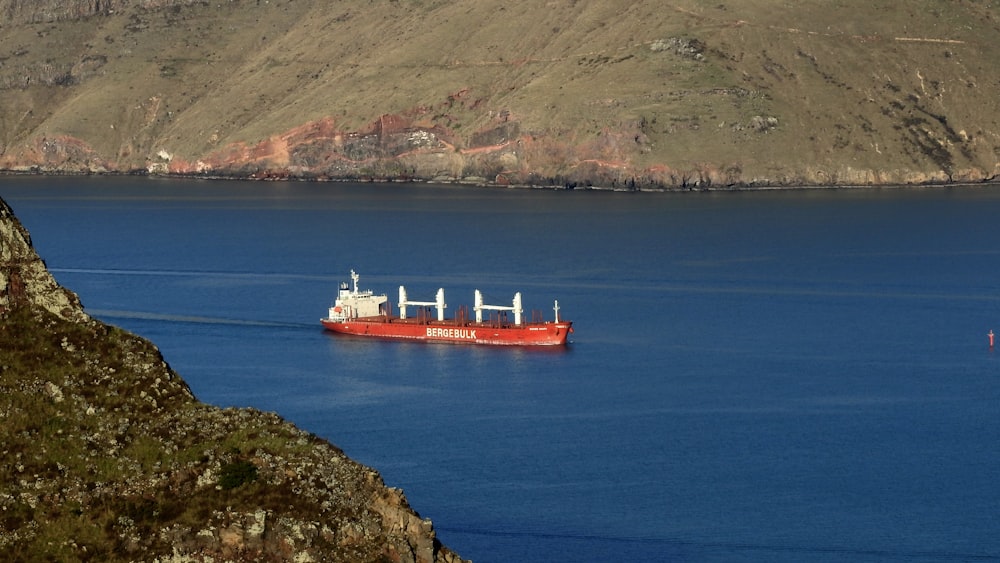 red ship on blue sea during daytime