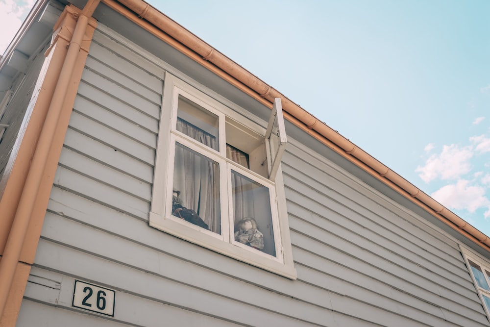 white wooden house with white wooden window